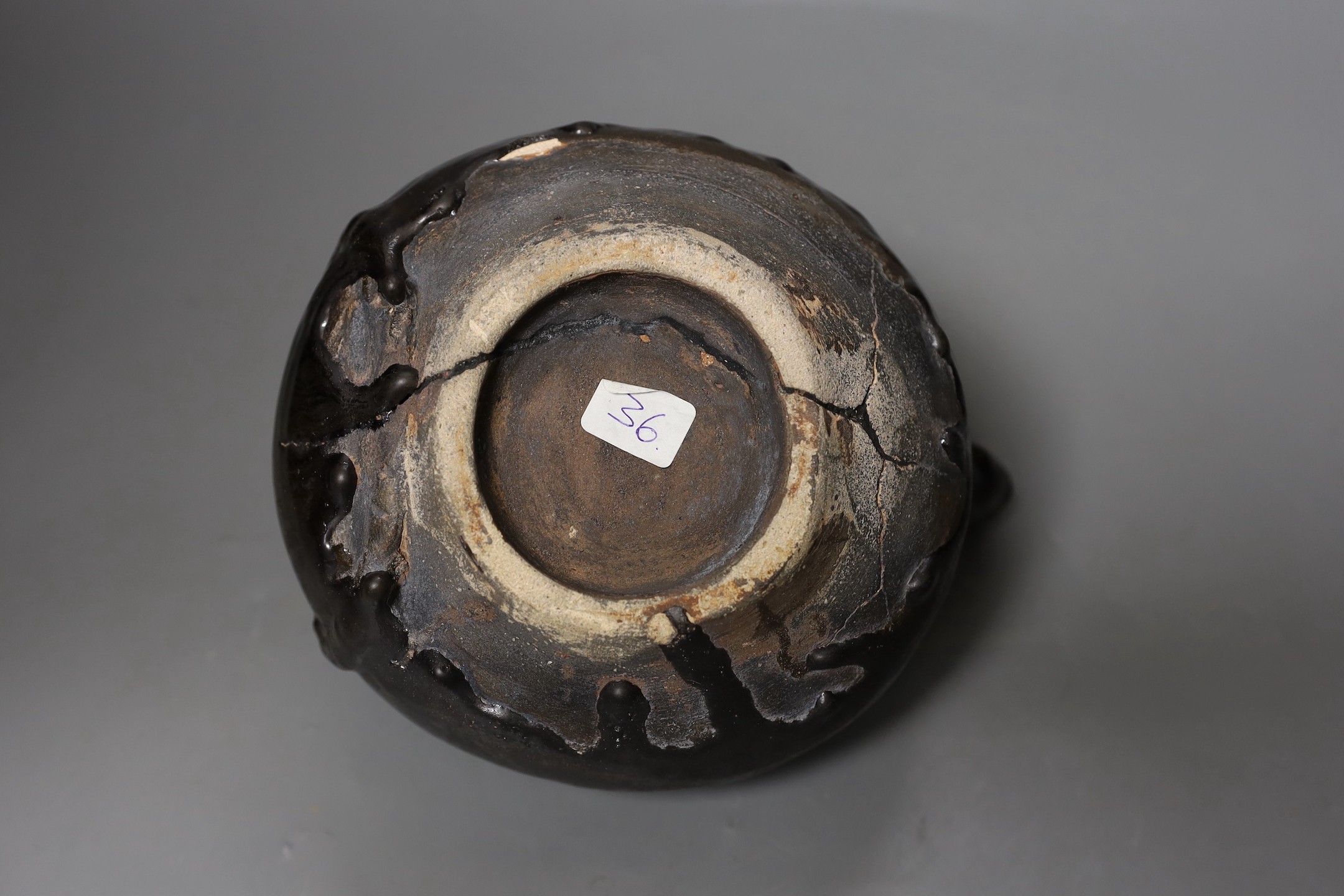 A South East Asian black glazed pottery ‘tortoise’ kendi, possibly Indonesian, 20cms wide